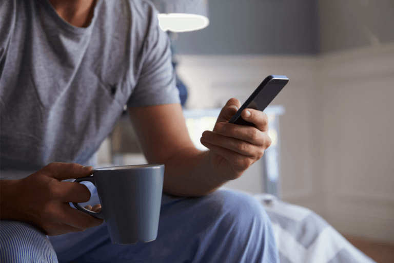 Man reading dental practice newsletter on phone